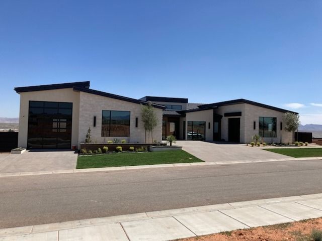 A large house with a lot of windows on the side of a road